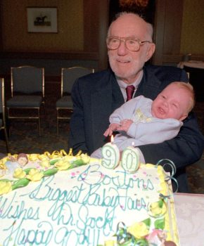 Famed child care specialist Dr. Benjamin Spock holds 3-month-old Ryan Michl at a Boston baby fair April 30, 1993. The birthday cake was presented to Dr. Spock to celebrate his 90th birthday, two days later. (AP Photo / Elise Amendola)